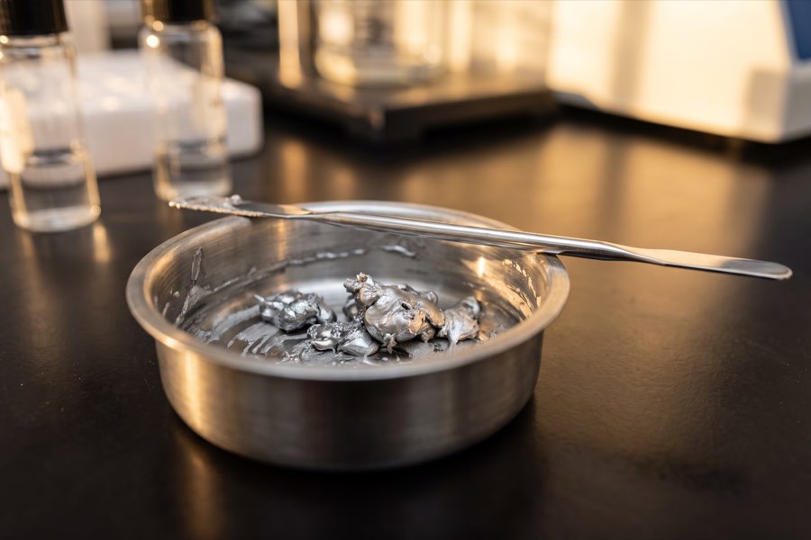Metal filings and sweepings collected in a small dish for assay